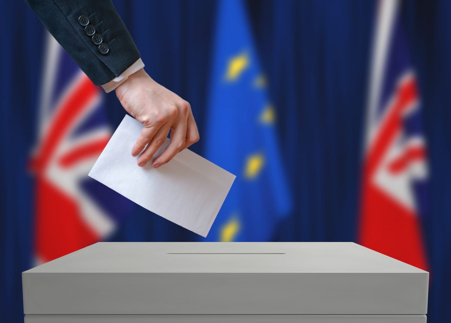 Election or referendum in Great Britain. Voter holds envelope.